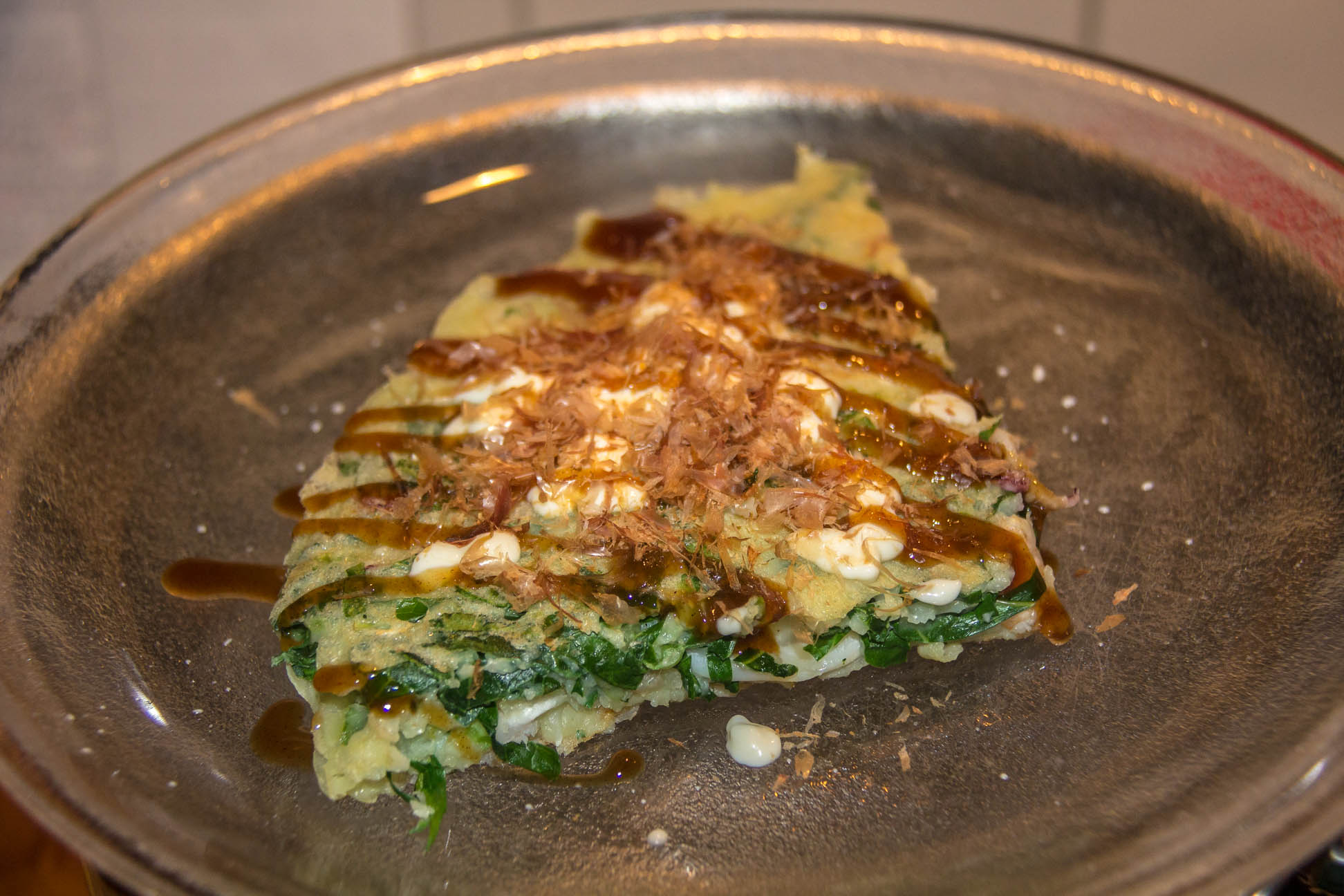05/07/15 A slice of the finished dish with Japanese mayo and Okonomiyaki sauce and fish flakes 