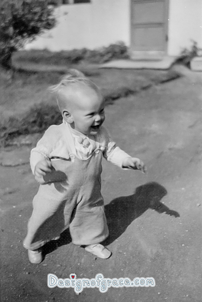 old black and white photo of a baby walking