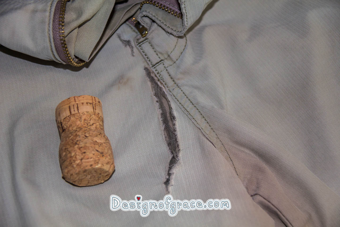 Photo of a ripped pants in the front, cork use to show the size of the rip