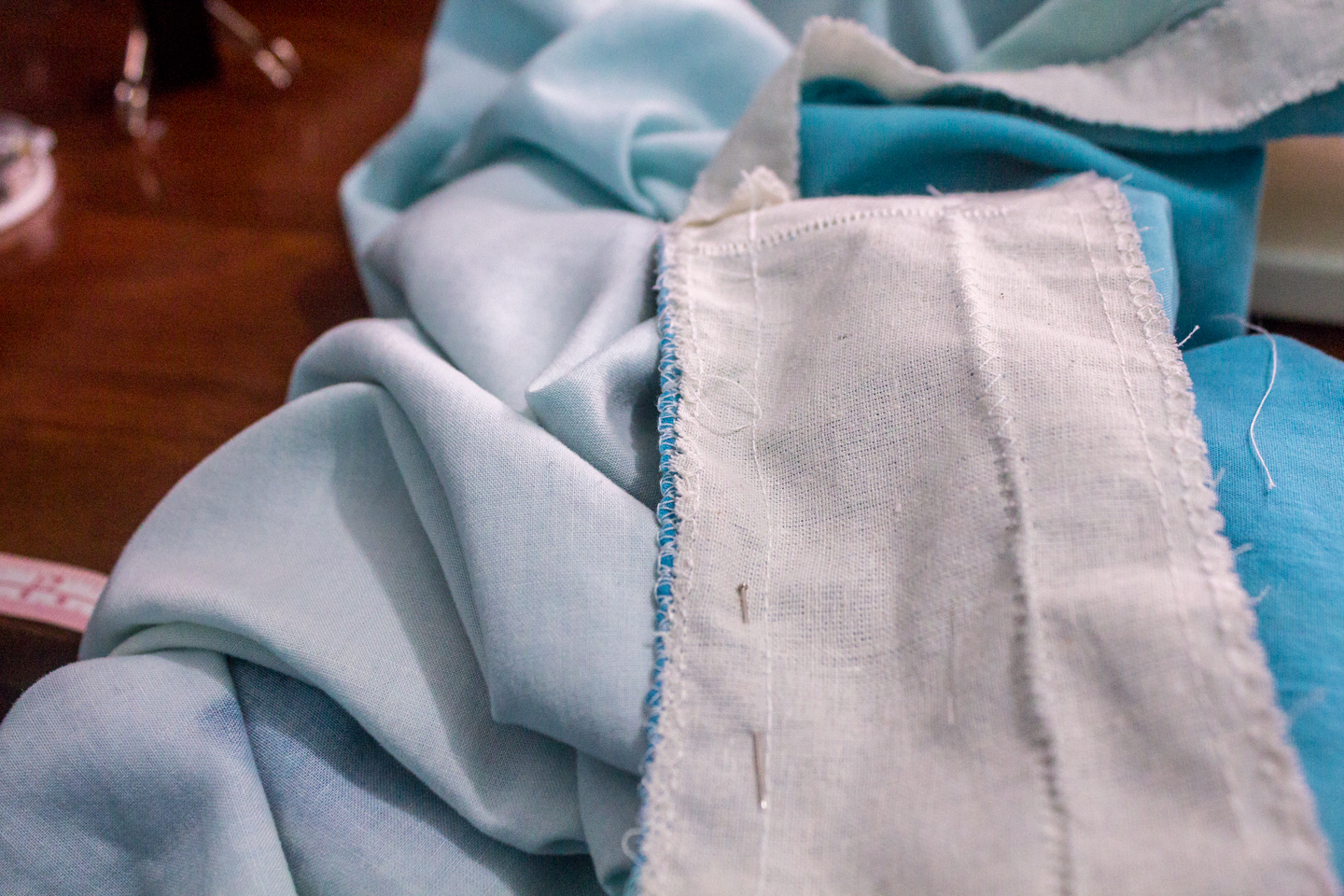 Now line up the calico layer to the plain fabric and use the over lock stitch to secure both the fabrics