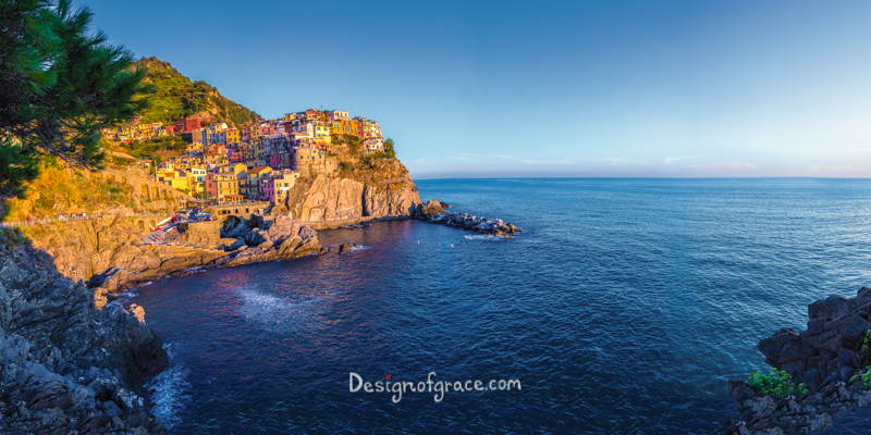 beautiful panorama of the town of Corniglia on the left in cinque terra and water on the right.