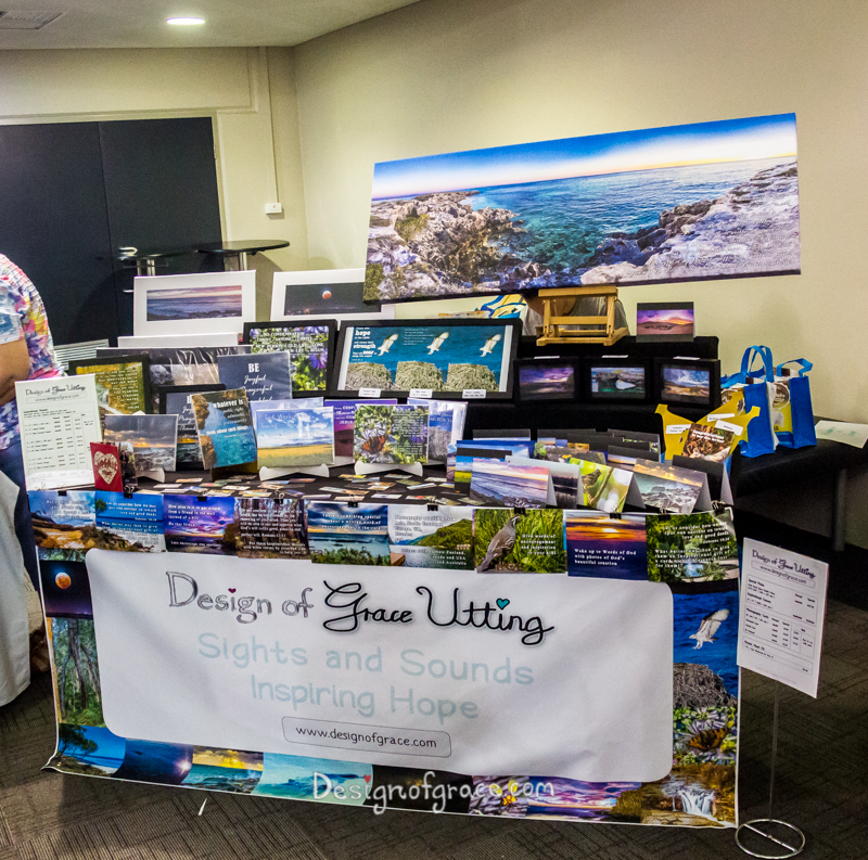 Here is my 1st ever market stall with a huge banner in the front of the table with my logo Design of Grace Utting and the slogan Sights and Sounds Inspiring Hope. There are mounted prints of nature photography on the left and middle of the table and cards on the right. There is also a huge canvas on the right of the table. at the Essence event at Mount Pleasant Baptist Church:)