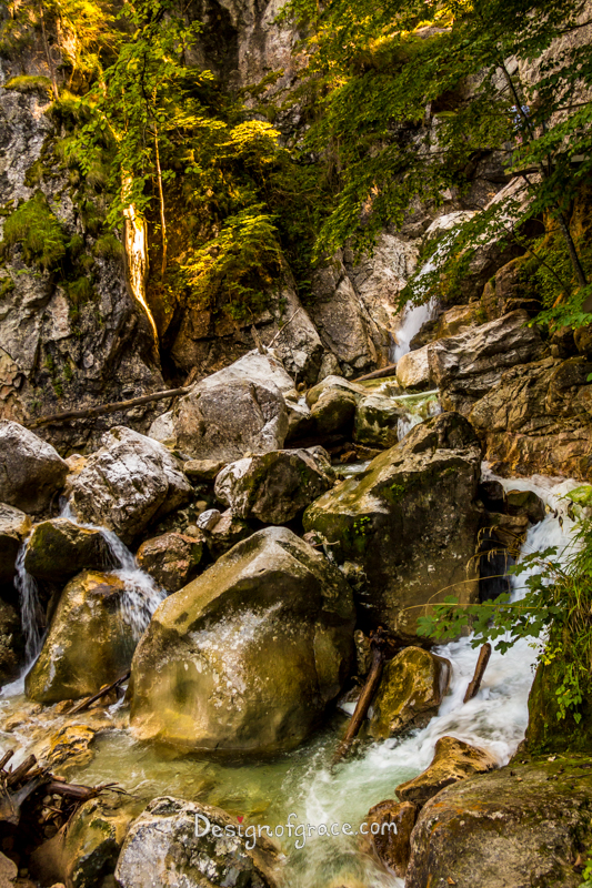 Waterfall with rocks surrounding during Hike up to Neuschwanstein Castle, Bavaria, Germany