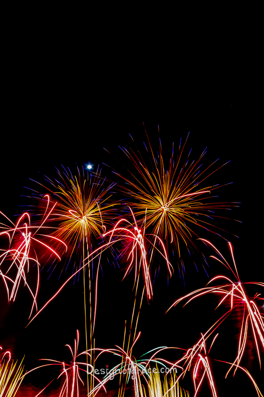 orange, pink red with blue tips Fireworks and the moon, Perth, Western Australia