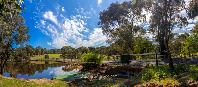 beautiful peaceful Meelup Brook panorama with beautiful blue skies and patches of clouds with still waters reflecting the surroundings and green trees on the left, Eagle Bay, Western Australia