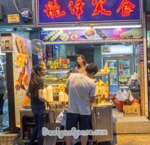 front view of the food stall where people are buying food