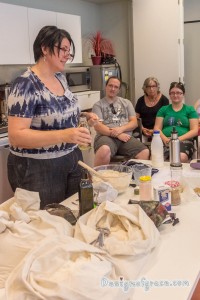 Elizabeth the presenter measuring ingredients and putting it in the mixing bowl with workshop participants watching