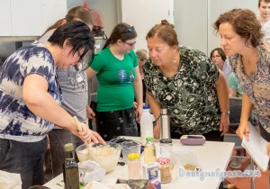 Elizabeth the presenter mixing the ingredients in the mixing bowl with workshop participants watching