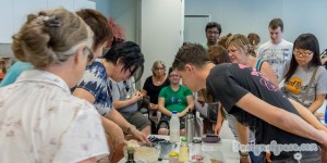 Elizabeth the presenter mixing the ingredients in the mixing bowl with workshop participants watching