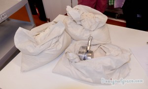 three sacks of flour with measuring cups in the bottom right bag