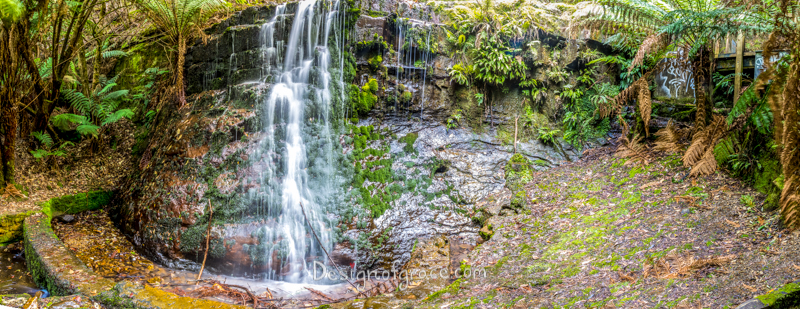 Panorama of a Silver Falls waterfall with greenery surrounding the scene. with the waterfall 2/3 to the left of the panorama. 